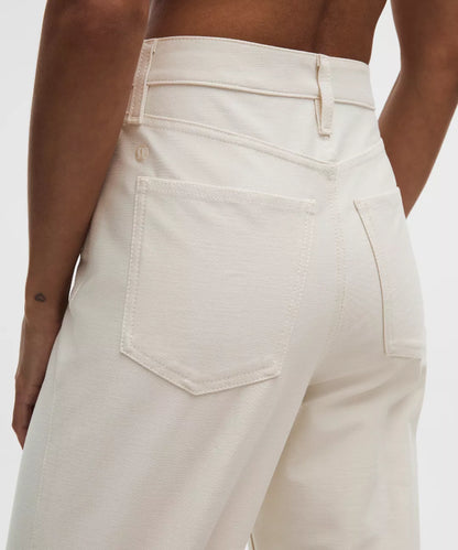 Close-up of beige pants with a neutral background