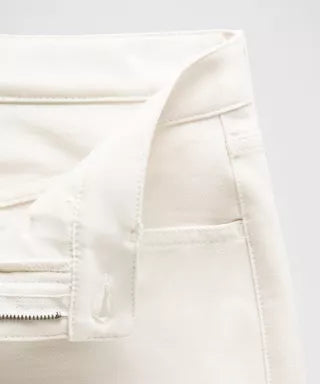 Close-up of a white jacket with a zipper on a light gray background