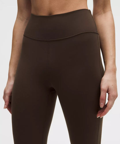 Brown leggings worn by a person on a white background