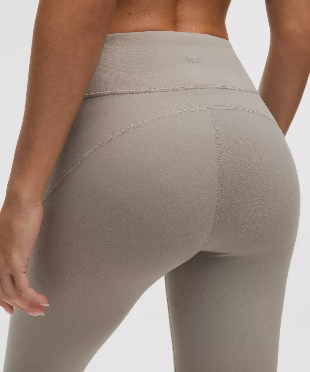 Beige leggings worn by a person on a plain background