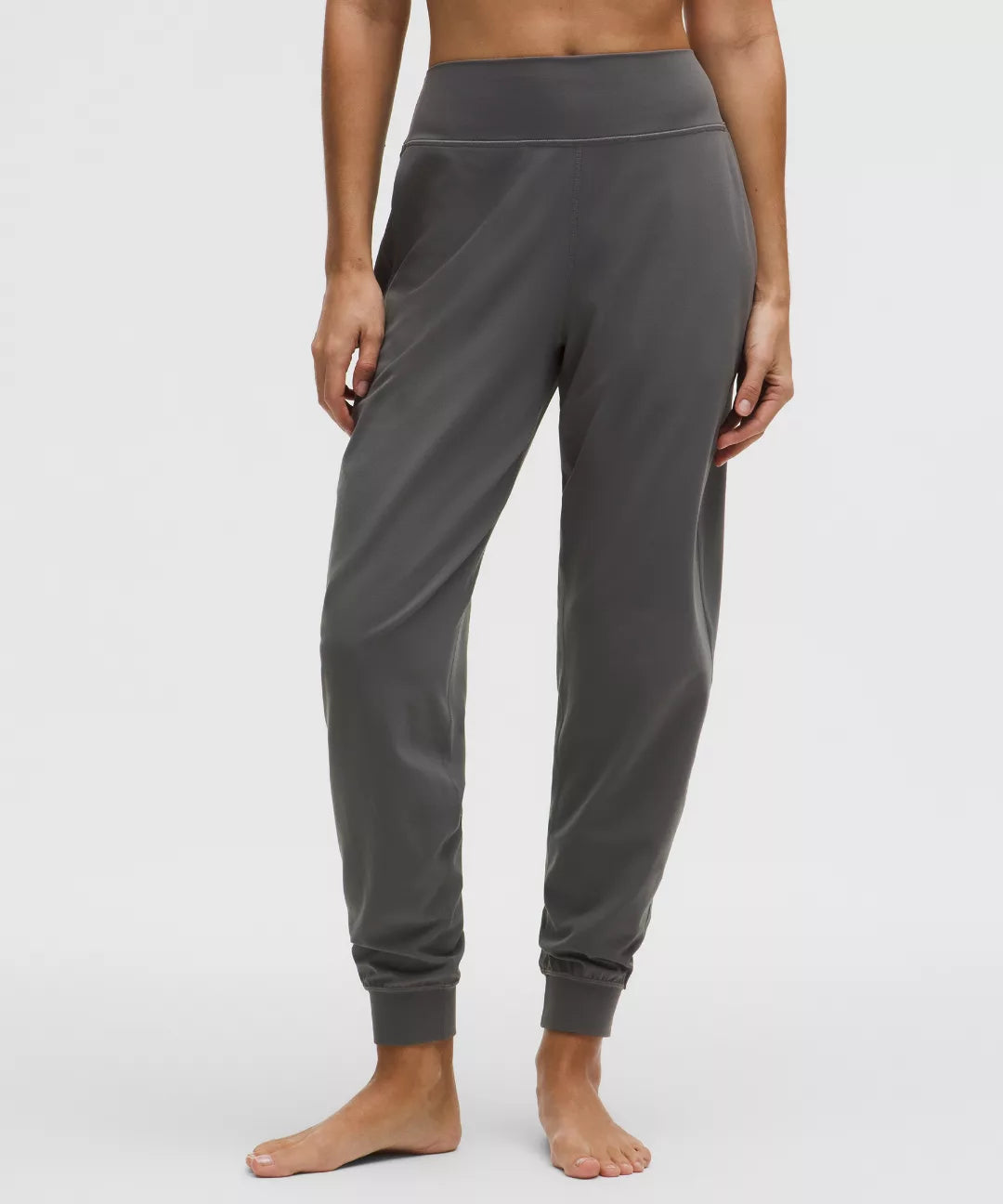 Person wearing gray sweatpants on a white background