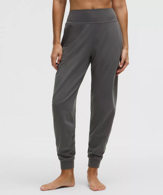 Person wearing gray sweatpants on a white background