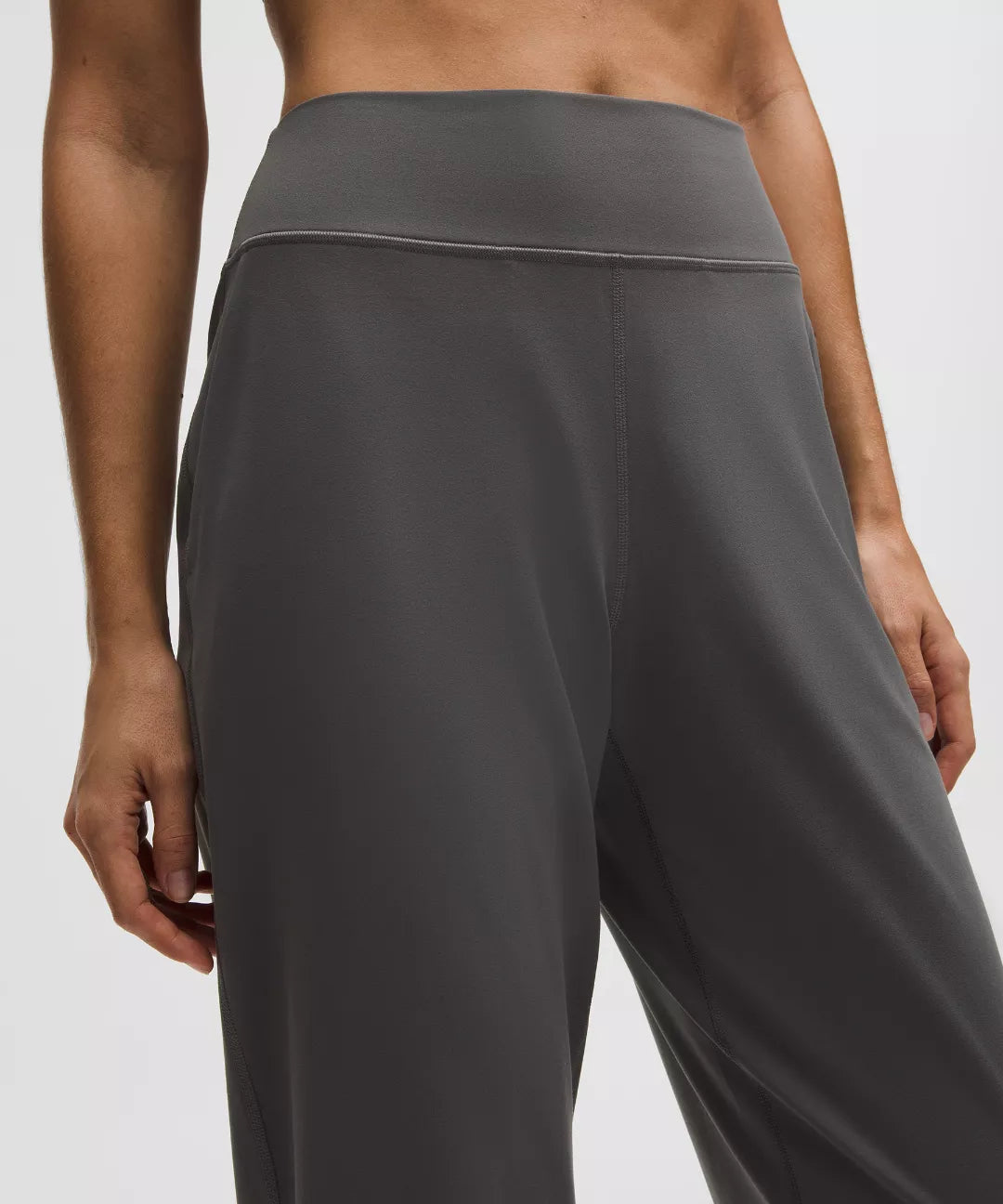Gray high-waisted pants on a plain background