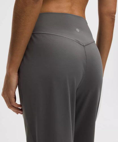 Gray leggings worn by a person on a white background
