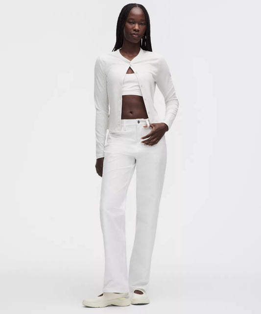 Woman wearing a white outfit on a plain background