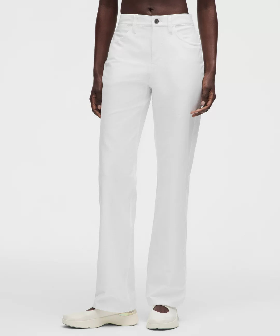 Person wearing white pants on a plain background