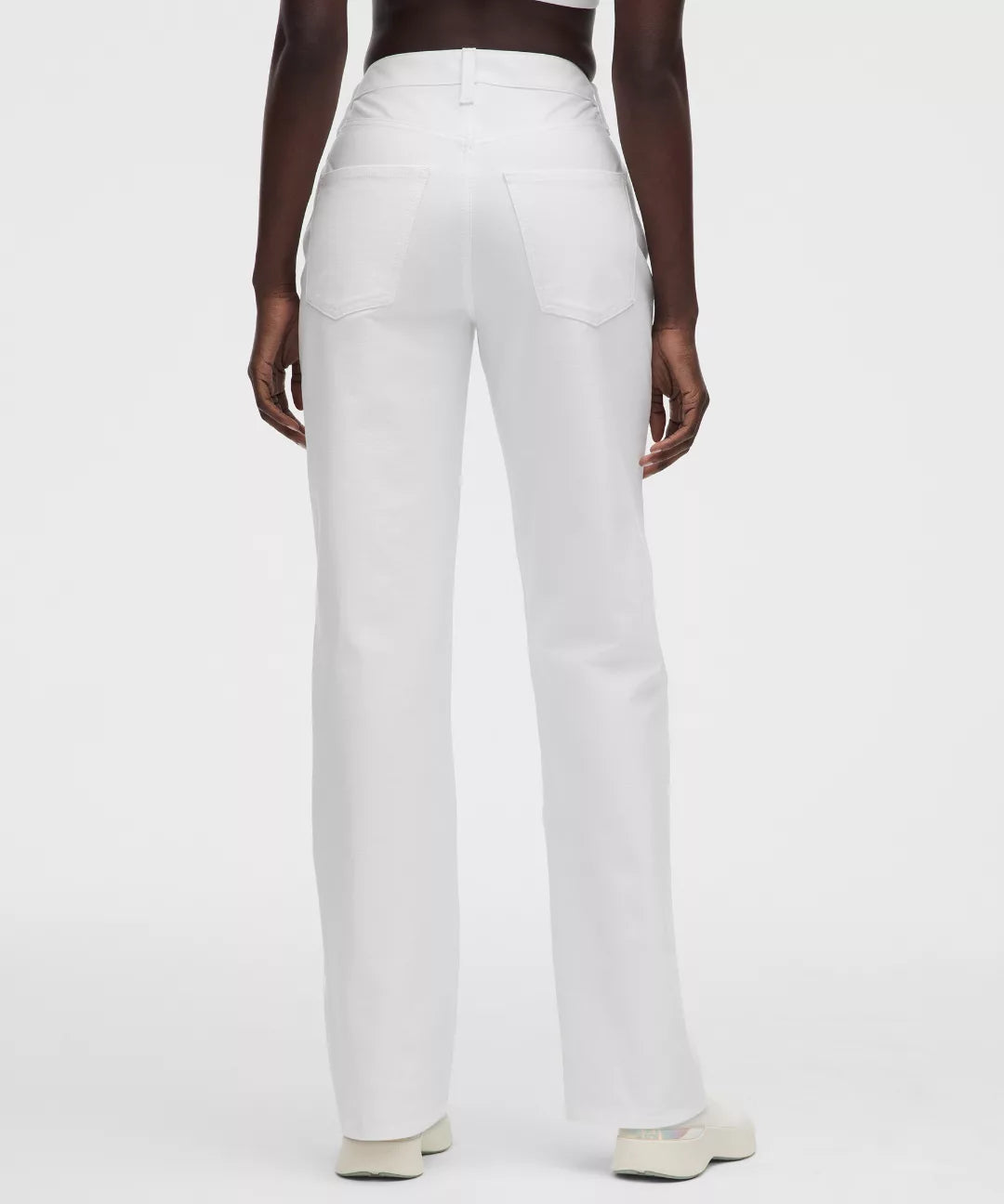 White pants worn by a person on a white background