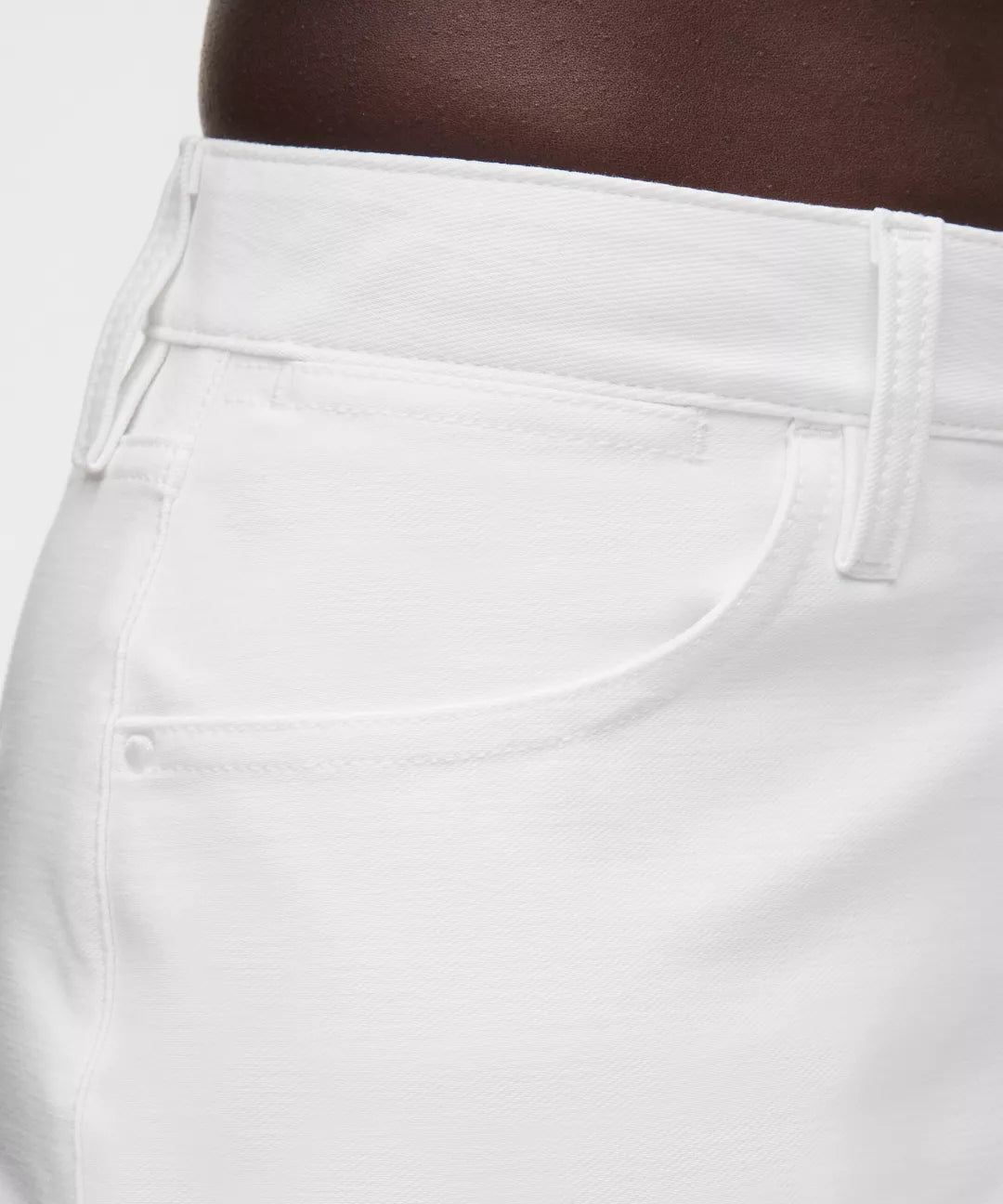 Close-up of white pants with a neutral background