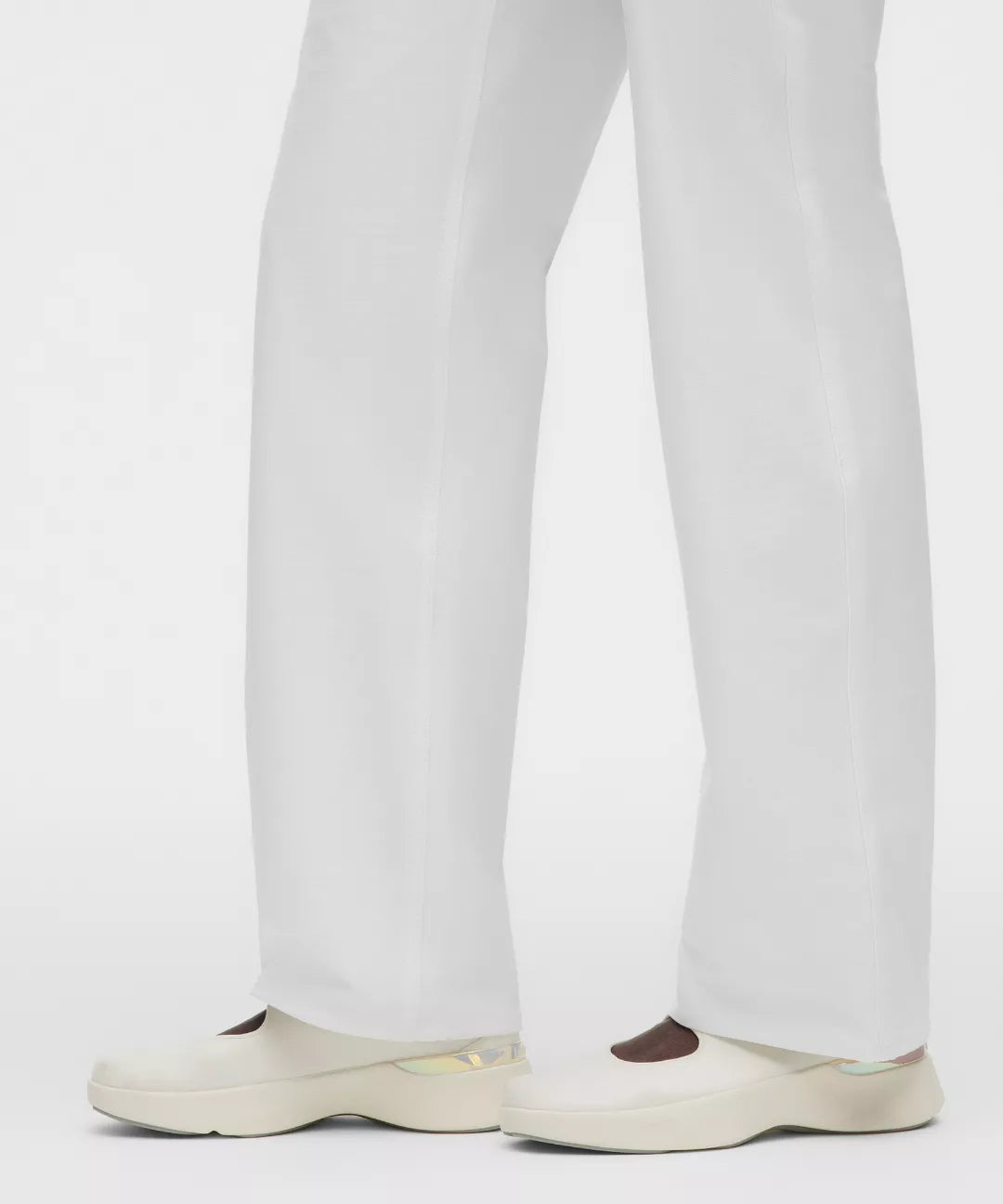 White pants worn by a person on a white background