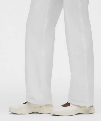 White pants worn by a person on a white background