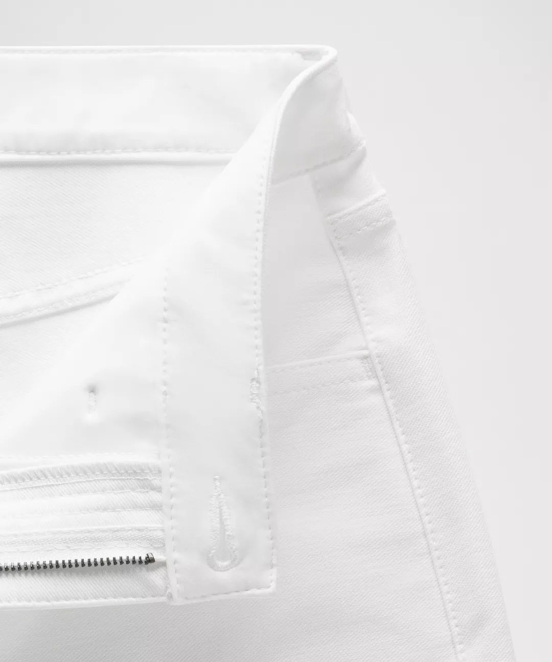 Close-up of a white jacket with zippers on a white background