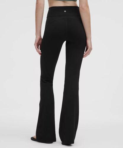 Black flared pants worn by a person on a white background