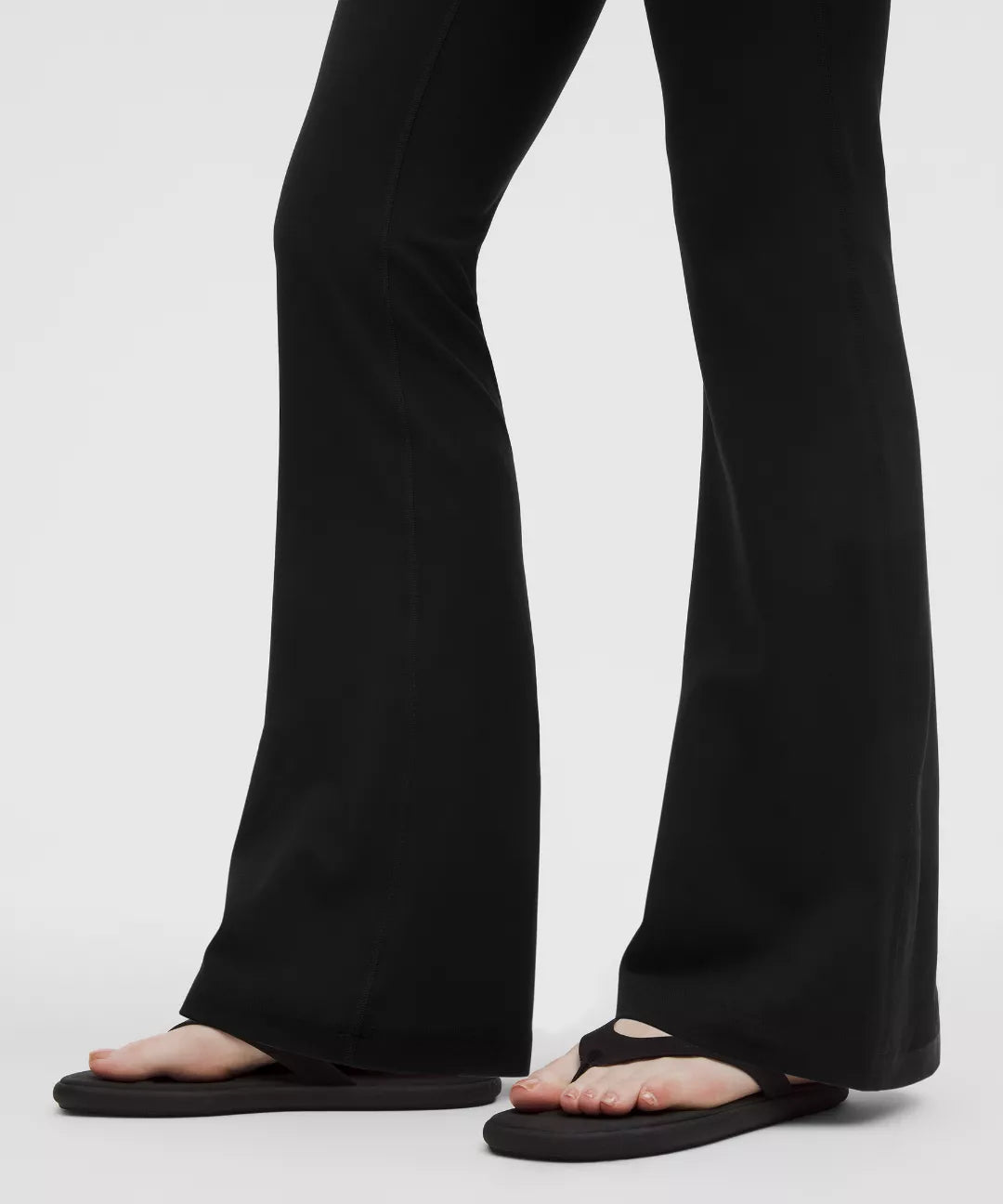 Black pants worn by a person on a white background