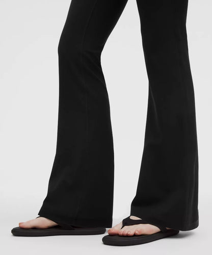 Black pants worn by a person on a white background
