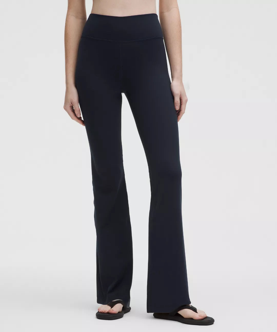 Person wearing black pants on a white background