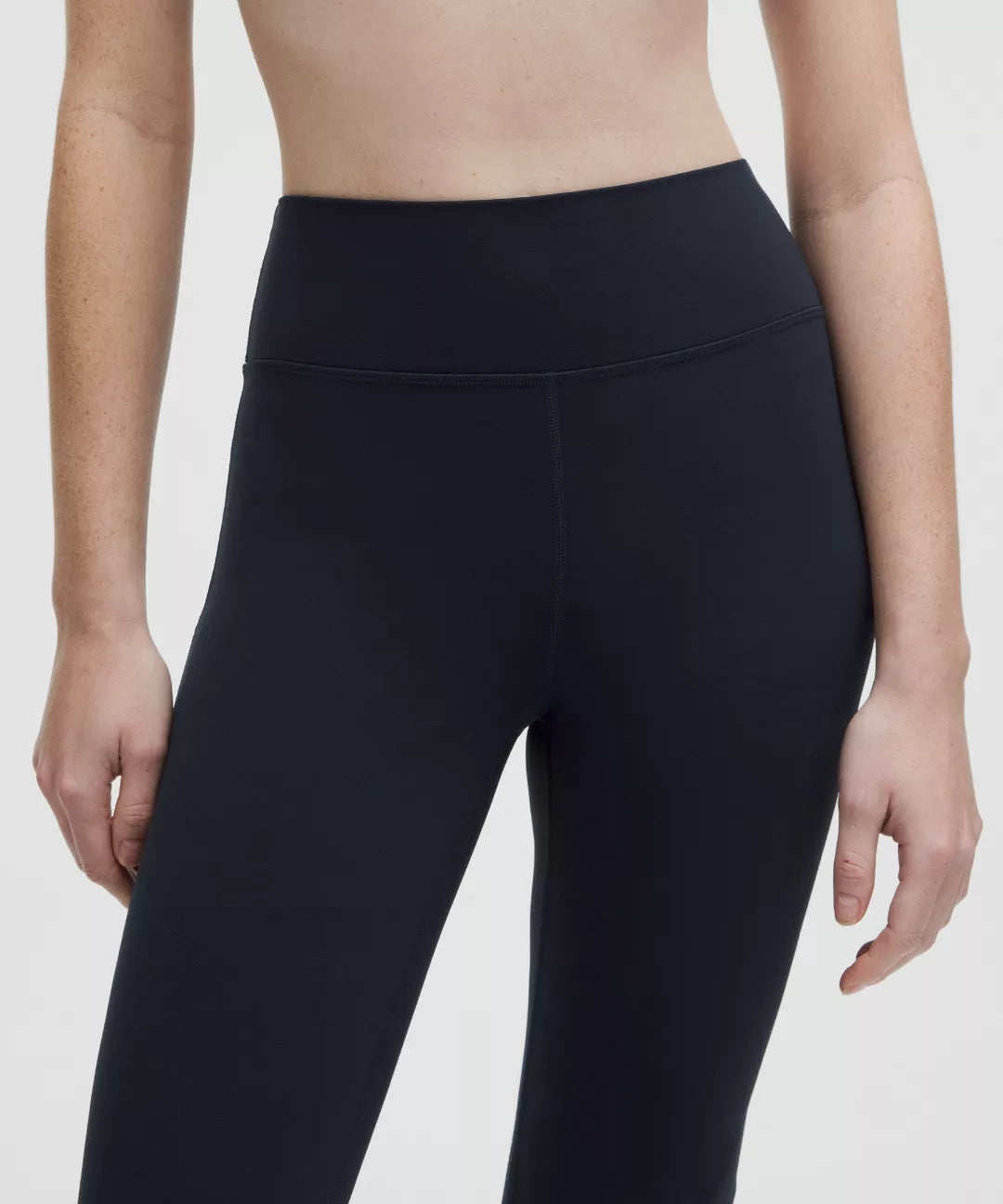 Black leggings worn by a person on a white background