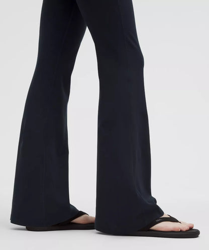 Black pants worn by a person on a white background