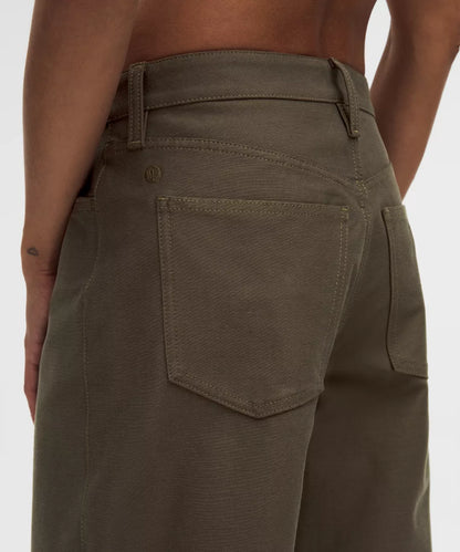 Brown pants worn by a person on a white background