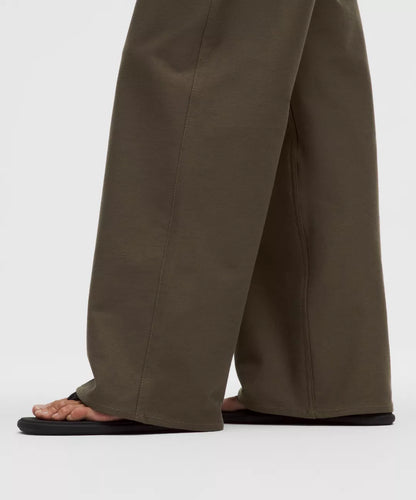 Brown wide-leg pants worn by a person on a white background