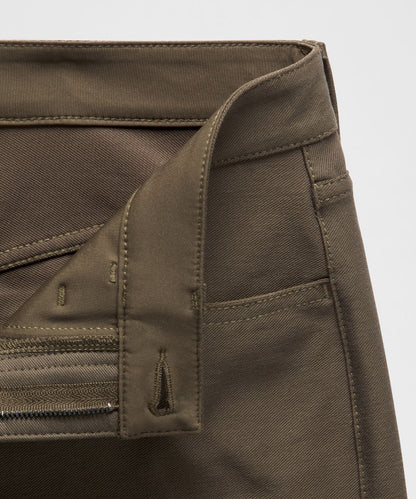 Close-up of a brown fabric with stitching details on a light gray background