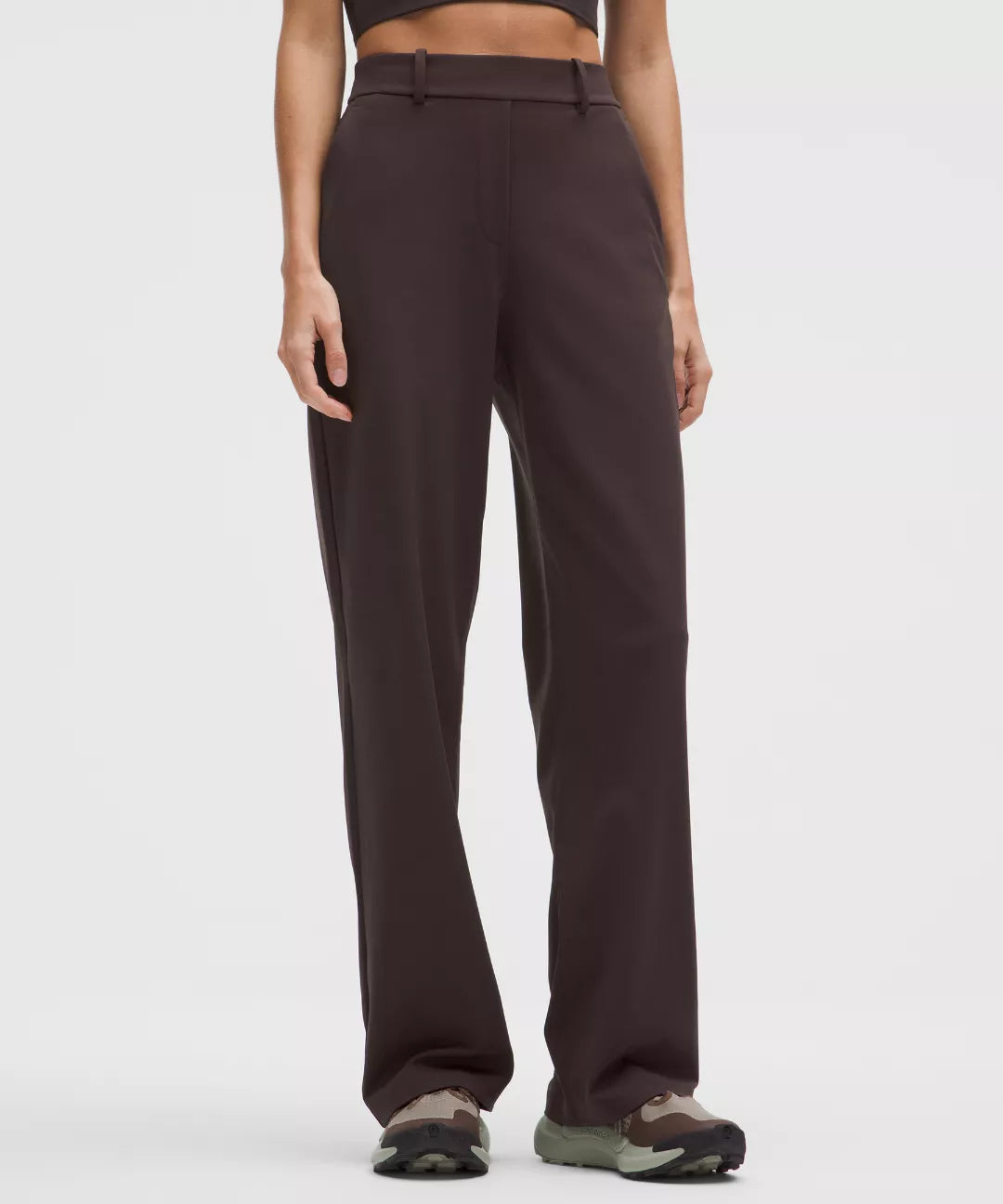 Brown pants worn by a person on a white background