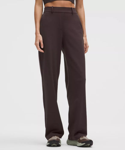 Brown pants worn by a person on a white background
