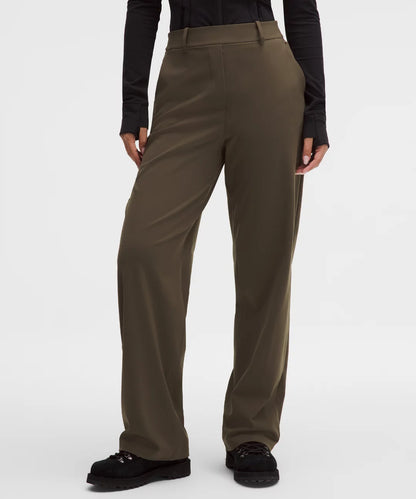 Brown pants worn by a person on a white background