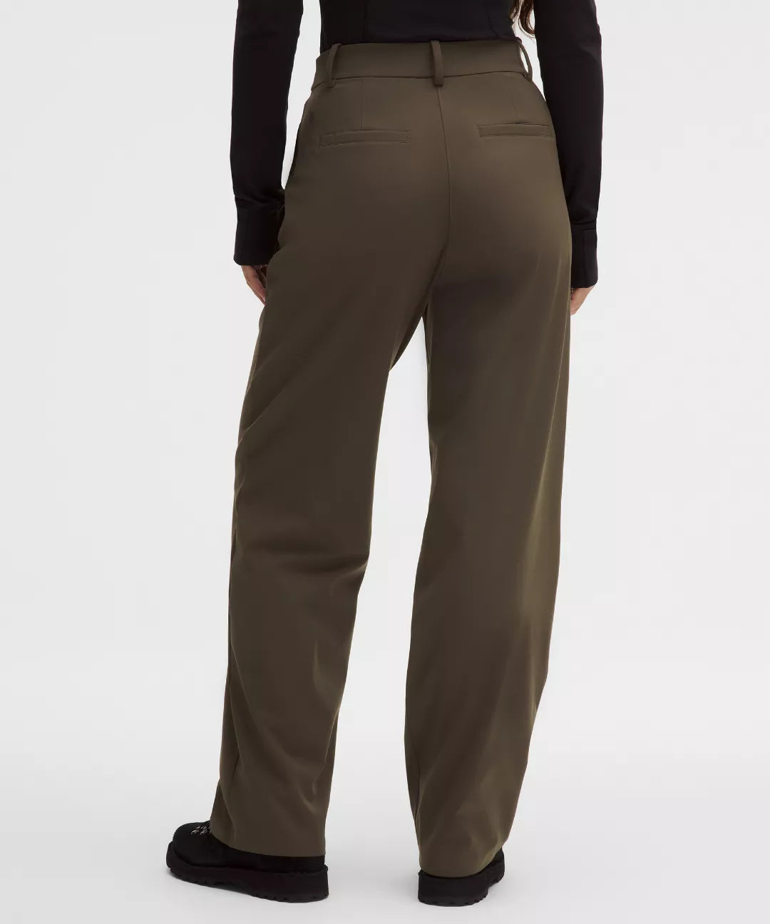 Brown pants worn by a person on a white background