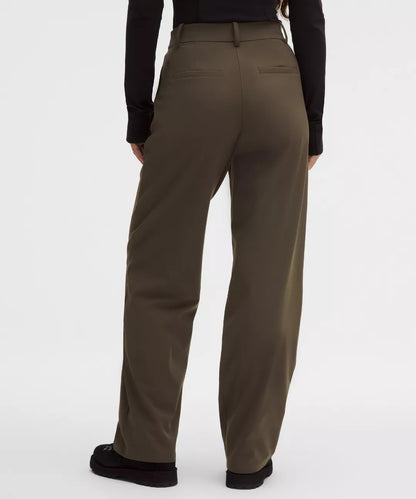 Brown pants worn by a person on a white background