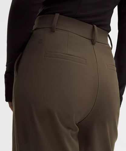 Brown pants worn by a person on a white background