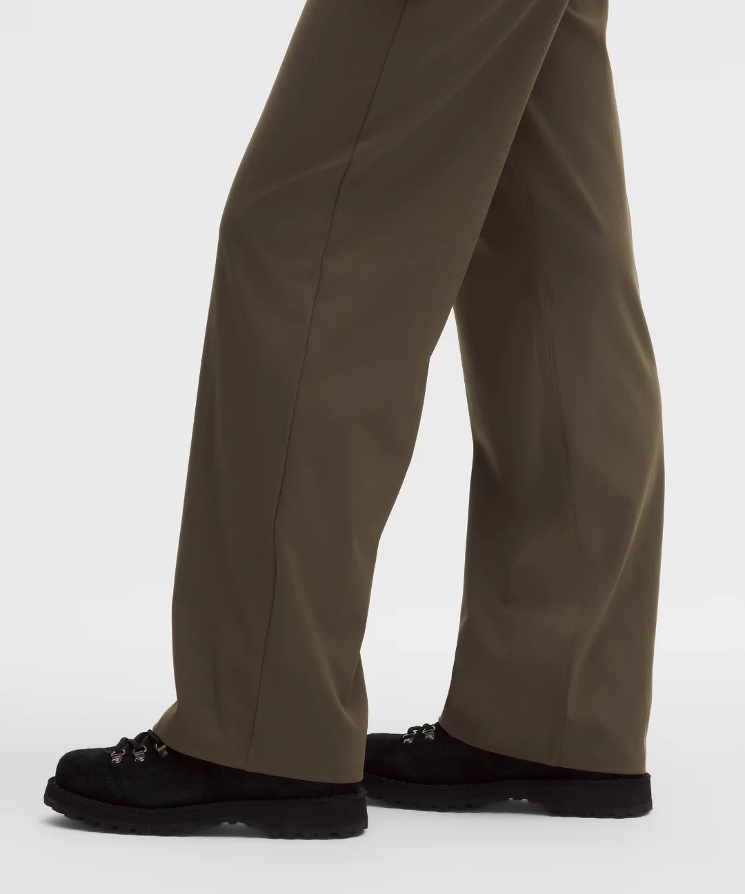 Brown pants worn by a person on a white background