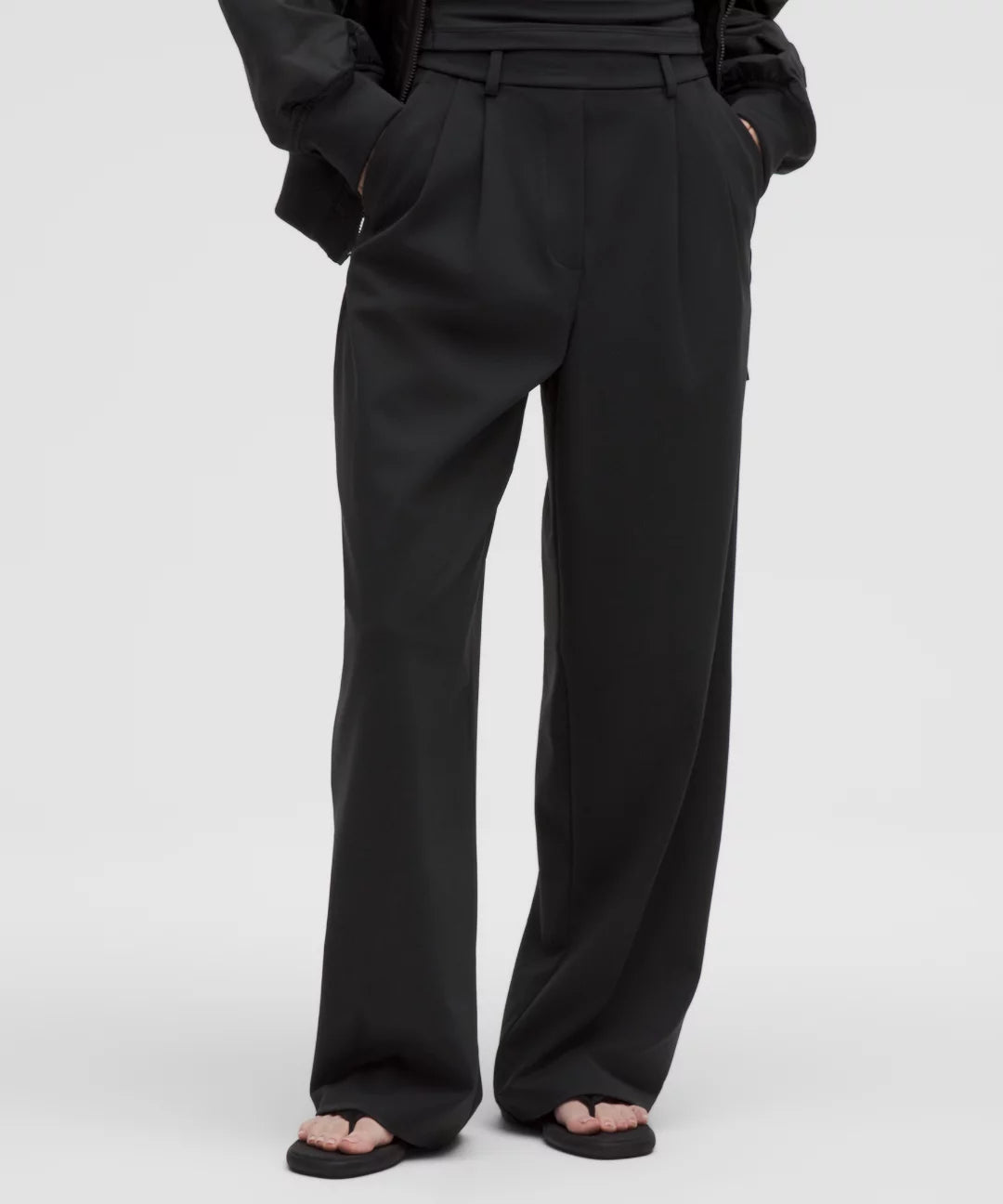 Black wide-leg pants worn by a person on a white background
