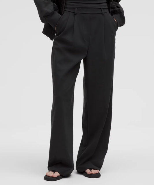 Black wide-leg pants worn by a person on a white background