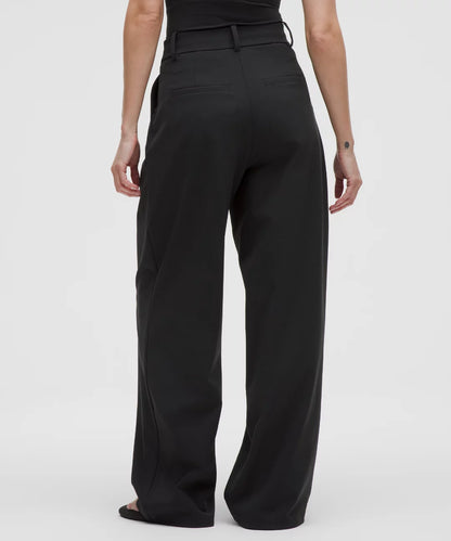 Black wide-leg pants worn by a person on a white background