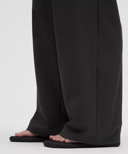 Black wide-leg pants worn by a person on a white background