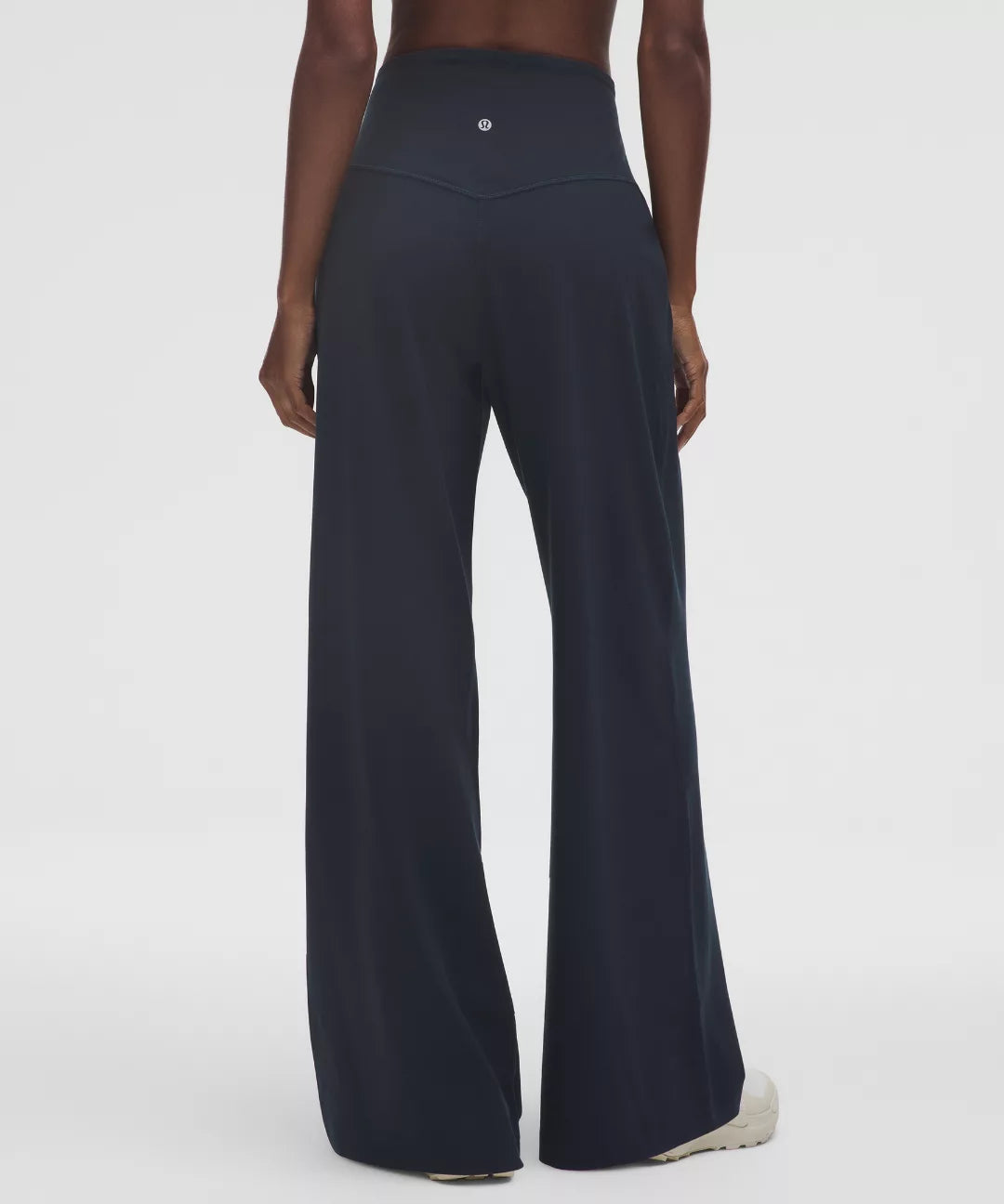 Black wide-leg pants worn by a person on a white background