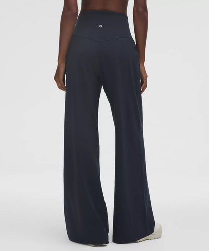 Black wide-leg pants worn by a person on a white background