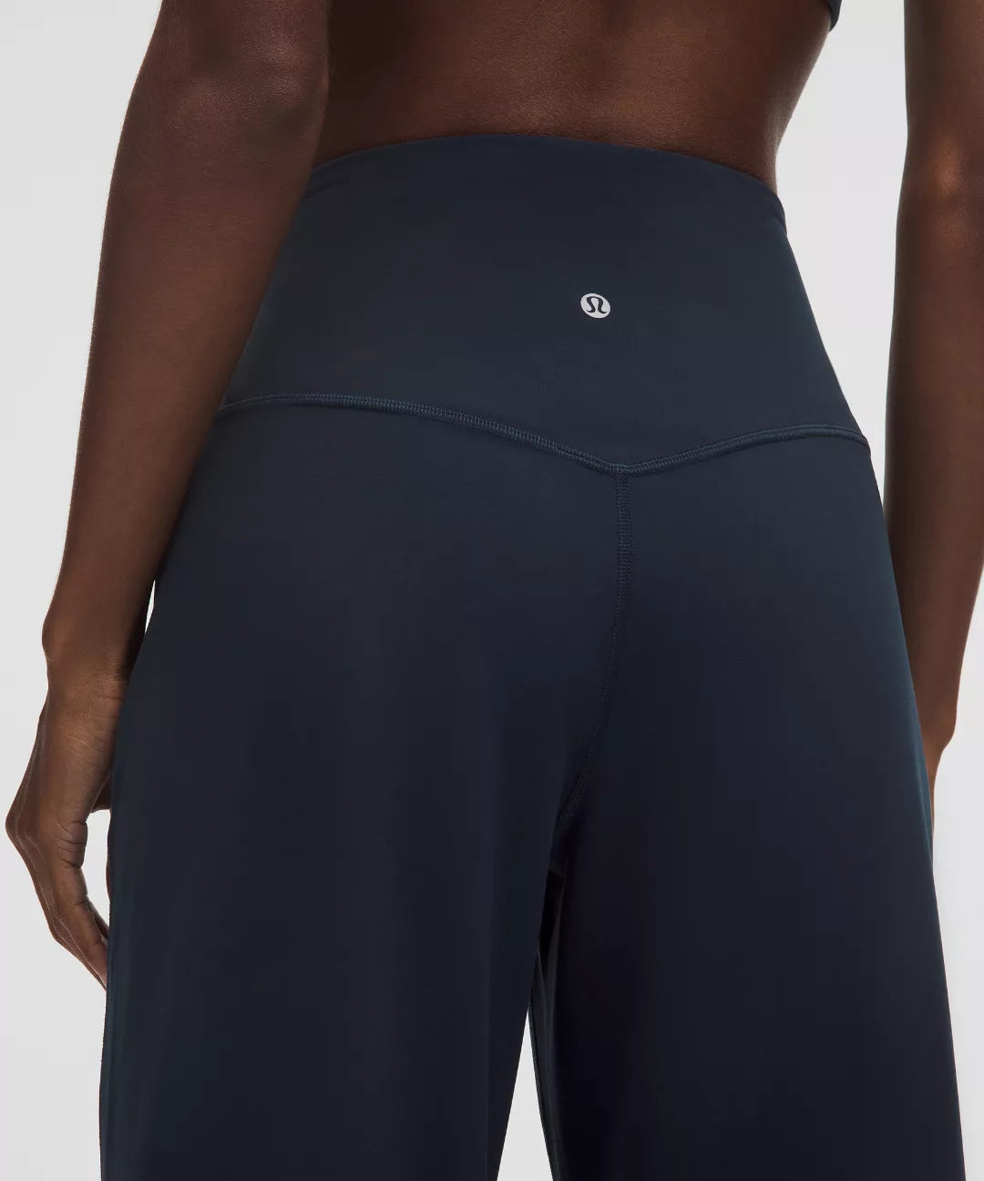 Dark gray leggings with a brand logo on a white background