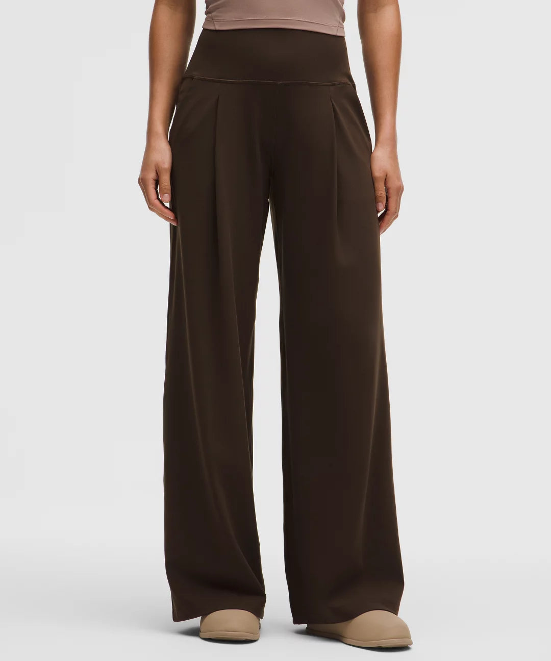 Brown wide-leg pants worn by a person on a white background
