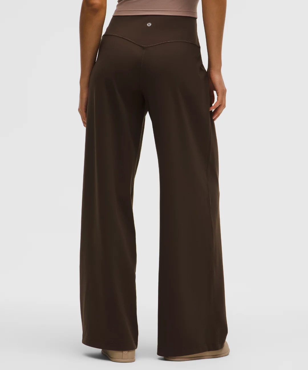 Brown wide-leg pants worn by a person on a white background
