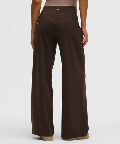 Brown wide-leg pants worn by a person on a white background