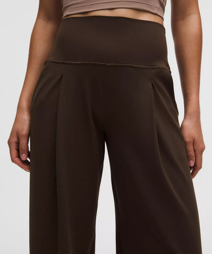 Brown wide-leg pants worn by a person on a white background