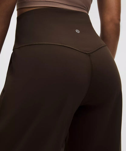 Brown athletic leggings with a logo on a plain background