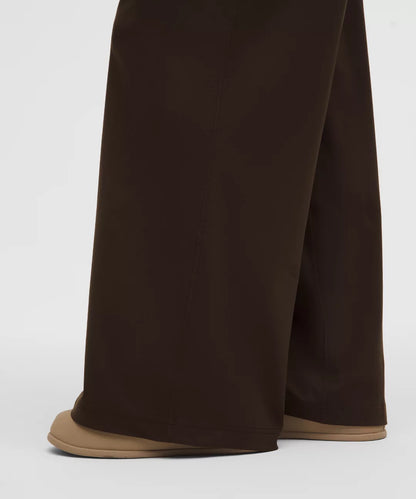 Brown wide-leg pants worn by a person on a white background