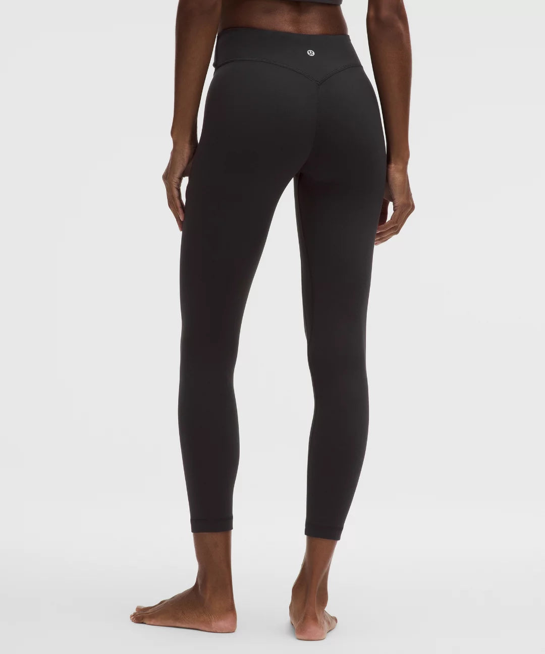 Black leggings worn by a person on a white background