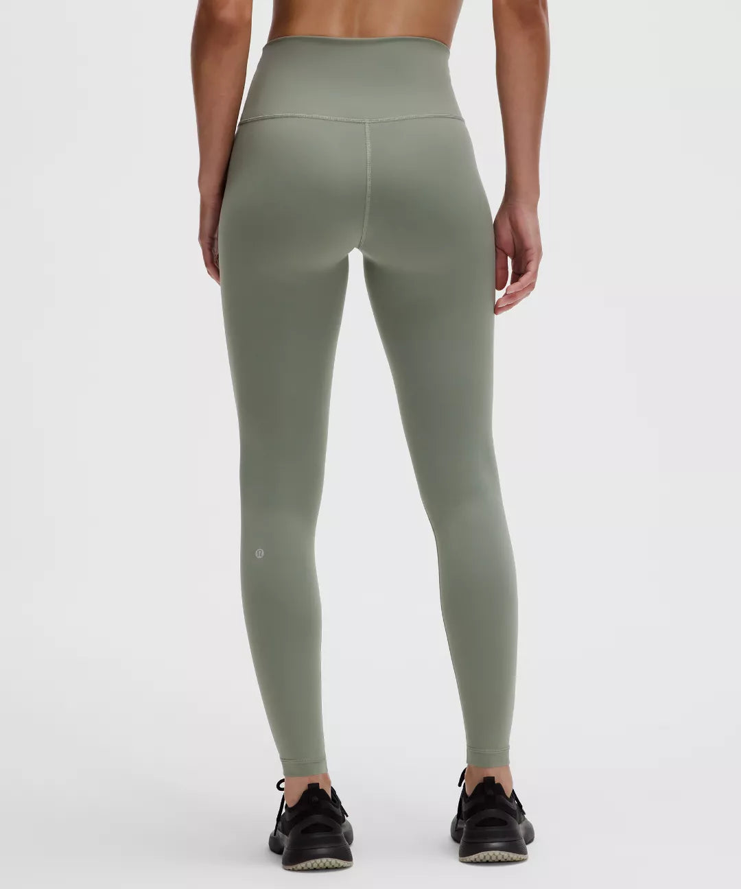 Green leggings worn by a person on a white background
