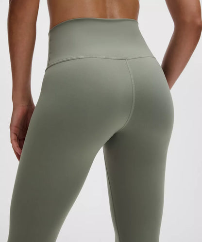 Green leggings worn by a person on a white background