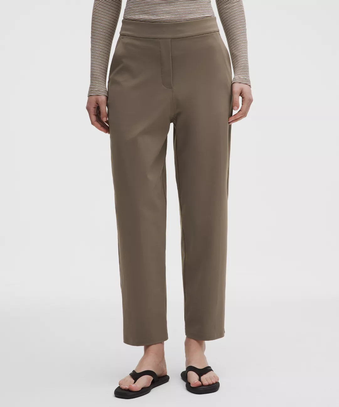 Person wearing brown pants on a white background