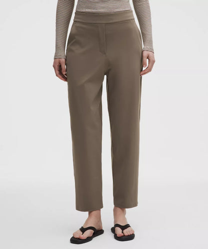 Person wearing brown pants on a white background