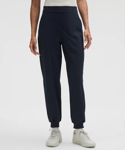 Person wearing navy blue sweatpants on a white background